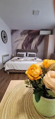 a bedroom with a bed with yellow flowers on the floor at Soko Bajka 1 in Soko Banja
