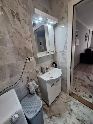 a bathroom with a sink and a mirror at Apartman MILOVANOVIĆ in Vrnjačka Banja