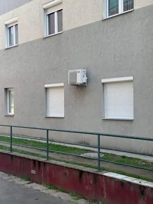 a building with windows and a air conditioner on it at Apartman Nada in Jagodina
