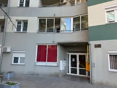an apartment building with a door and a balcony at Apartman Nada in Jagodina