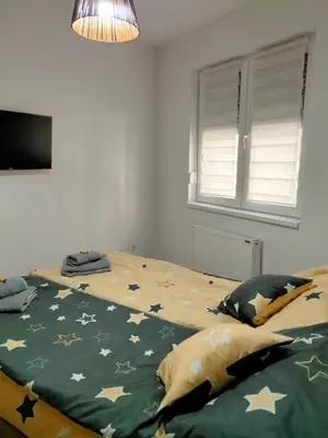 a bedroom with a bed with stars on it at Apartman Nada in Jagodina
