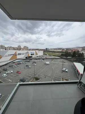 a view of a parking lot from a building at Delta Planet Apartman in Niš