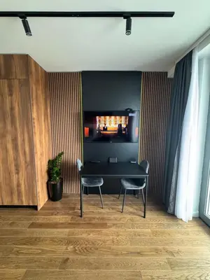 a dining room with a table and two chairs at Delta Planet Apartman in Niš