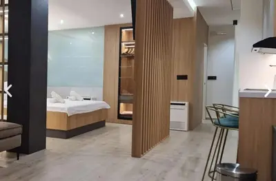 a bedroom with a bed and a glass door at Apartman La Casa and Spa in Vranje