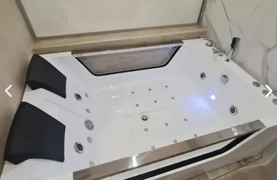 a bathtub in the corner of a room at Apartman La Casa and Spa in Vranje