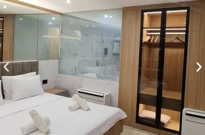 a room with two beds and a glass shower at Apartman La Casa and Spa in Vranje