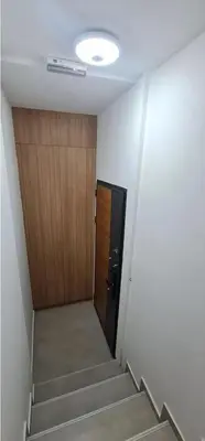 a hallway with a door and stairs in a building at Apartman La Casa and Spa in Vranje