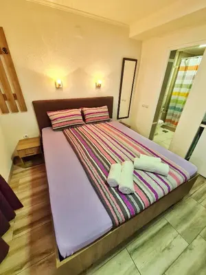 a large bed with two towels on top of it at Vila Aleksandra 2 studio 4 in Soko Banja