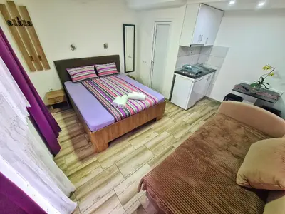 a small bedroom with a bed and a couch at Vila Aleksandra 2 studio 4 in Soko Banja