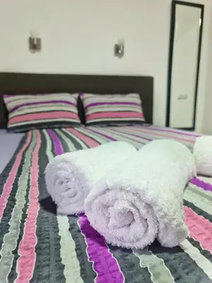 a white stuffed animal laying on a bed at Vila Aleksandra 2 studio 4 in Soko Banja