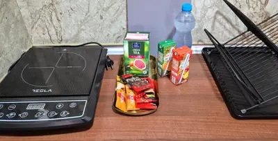 a table with a cell phone and some food and a grill at Apartmani IMW in Zaječar