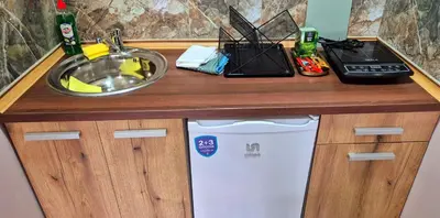 a kitchen counter with a sink and a white dishwasher at Apartmani IMW in Zaječar