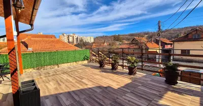 a balcony with potted plants on top of a building at Apartmani IMW in Zaječar