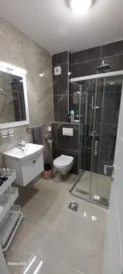 a bathroom with a shower and a toilet and a sink at Apartman 018 in Soko Banja