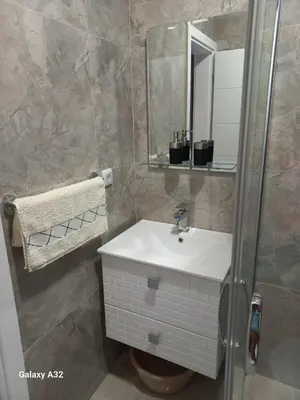 a bathroom with a sink and a mirror at Apartman 018 in Soko Banja