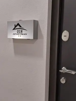 a door with a sign on it next to a room at Apartman 018 in Soko Banja