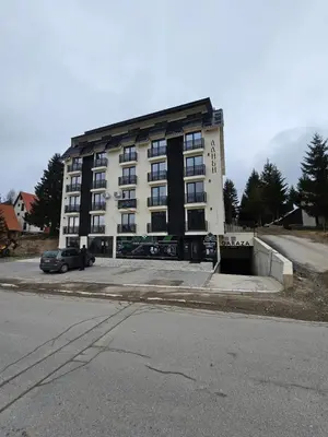 a large building with a car parked in front of it at Kopaonik Alibi IRIS10 in Kopaonik
