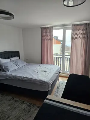 a bedroom with a bed and a large window at Kopaonik Alibi IRIS10 in Kopaonik