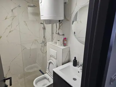 a bathroom with a toilet and a sink at Kopaonik Alibi IRIS10 in Kopaonik