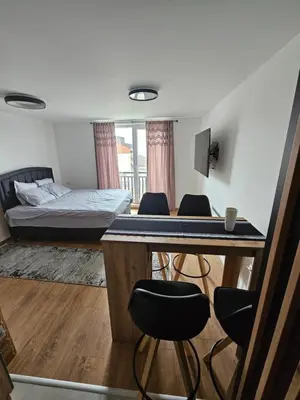 a room with a table and chairs and a bed at Kopaonik Alibi IRIS10 in Kopaonik