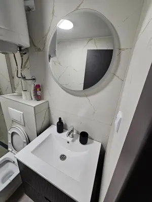 a bathroom with a white sink and a mirror at Kopaonik Alibi IRIS10 in Kopaonik