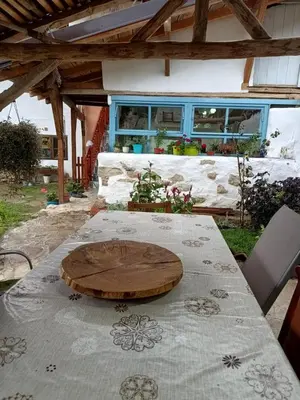 a table with a wooden plate on top of it at Vila Dika in Poganovo