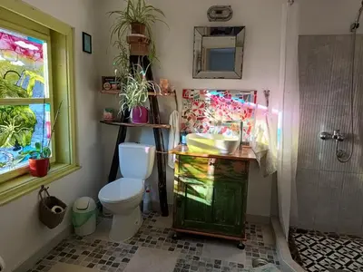 a bathroom with a toilet and a sink and a shower at Vila Dika in Poganovo