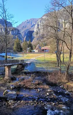 a bridge over a river with a mountain in the background at Vila Dika in Poganovo