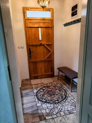 a door leading into a room with a tile floor at Vila Dika in Poganovo