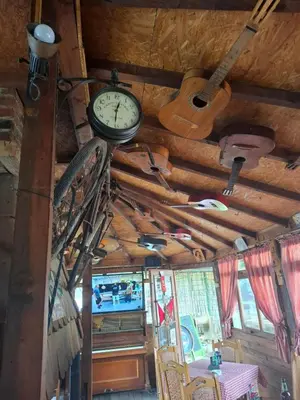 a clock hanging from the ceiling of a room at Viking apartaments in Niš
