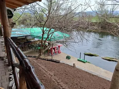 a view of a river from a porch of a house at Viking apartaments in Niš