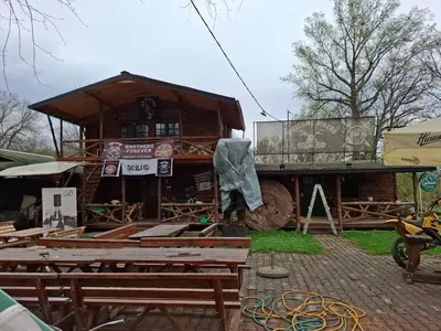 a building that is under construction in a yard at Viking apartaments in Niš