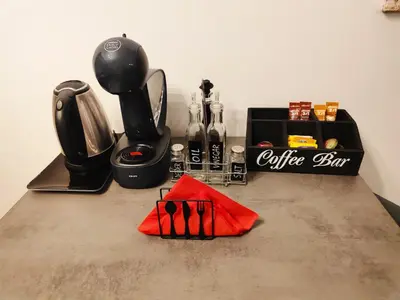 a counter top with a coffee maker and a coffee box at Apartman KUM in Vrnjačka Banja