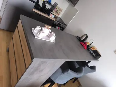 a kitchen with a table with two animals on it at Apartman KUM in Vrnjačka Banja