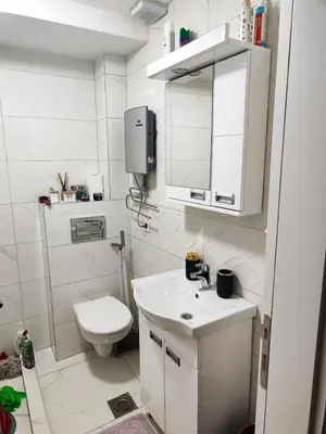 a small bathroom with a toilet and a sink at Apartman KUM in Vrnjačka Banja