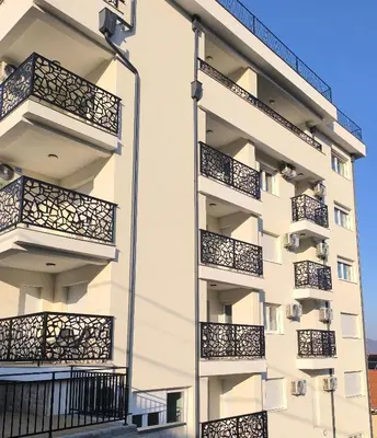 an apartment building with balconies on the side at Apartman KUM in Vrnjačka Banja
