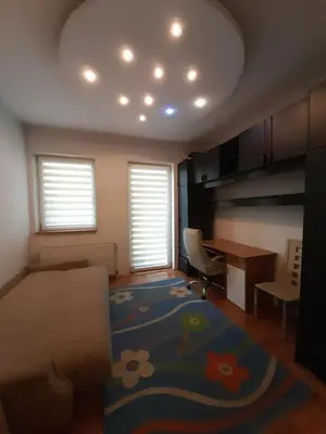 a bedroom with a bed and a desk and a table at Centar & peace in Niš