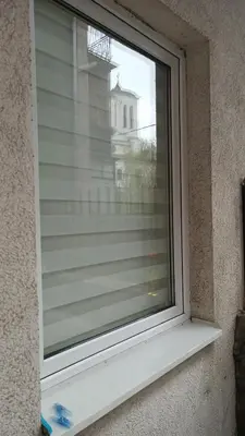 a window with a view of a building at Centar & peace in Niš