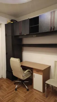 a office with a chair and a desk and cabinets at Centar & peace in Niš