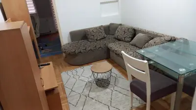 a living room with a couch and a table at Centar & peace in Niš