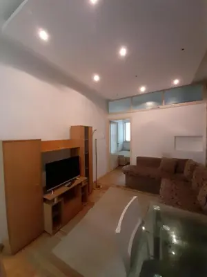 a living room with a couch and a flat screen tv at Centar & peace in Niš