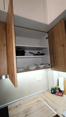 a kitchen with wooden cabinets and a counter top at Apartman Jana in Vrnjačka Banja