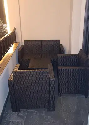 three wicker chairs and tables sitting on a balcony at Apartman Jana in Vrnjačka Banja