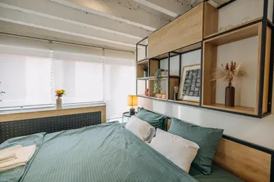 a bedroom with a bed and a shelf above it at Studio49apartments Quiet in Niš Free Private Parking Fast WiFi in Niš
