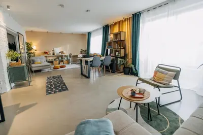 a living room with a couch and a table at Studio49apartments Quiet in Niš Free Private Parking Fast WiFi in Niš