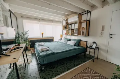 a bedroom with a bed and a desk in it at Studio49apartments Quiet in Niš Free Private Parking Fast WiFi in Niš