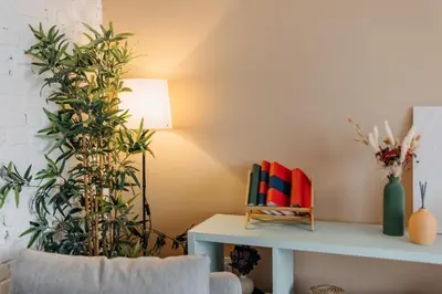 a living room with plants and a table with a lamp at Studio49apartments Quiet in Niš Free Private Parking Fast WiFi in Niš