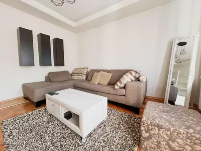 a living room with a couch and a coffee table at Elena apartman in Vranje