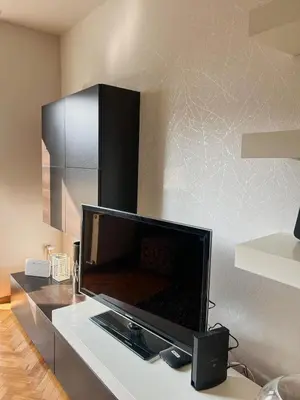 a flat screen tv sitting on top of a table at Elena apartman in Vranje