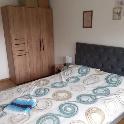 a bedroom with a bed with a black head board at Apartman Moj kutak 29 in Vrnjačka Banja